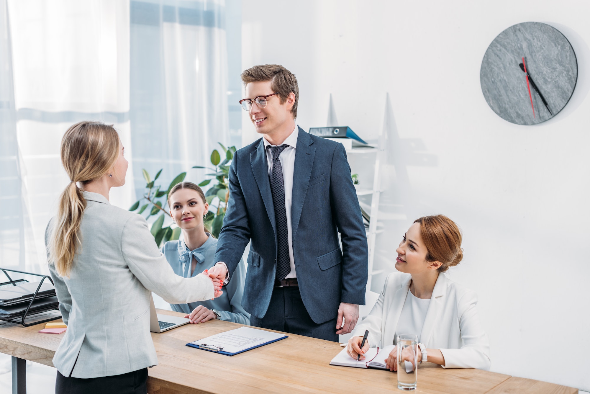 cheerful-man-in-glasses-shaking-hands-with-recruiter-on-job-interview.jpg